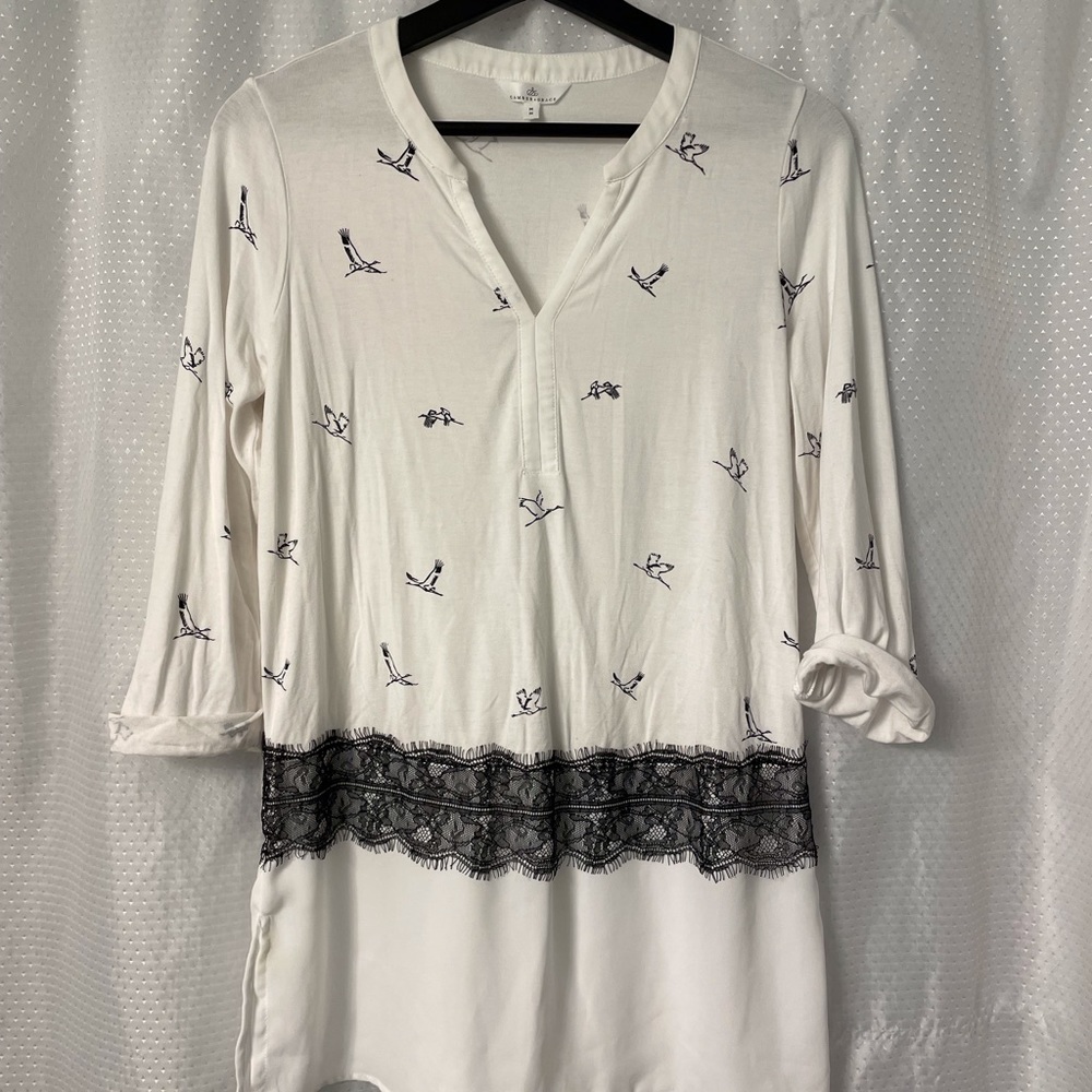 Tunic length blouse with cute detail.